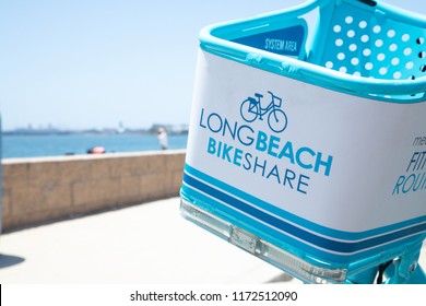 Long Beach, California / USA - June 2 2018: Close Up On Long Beach Bike Share Sign On Handlebar Basket, With Sandy Ocean Park In The Background And Space For Text On Left