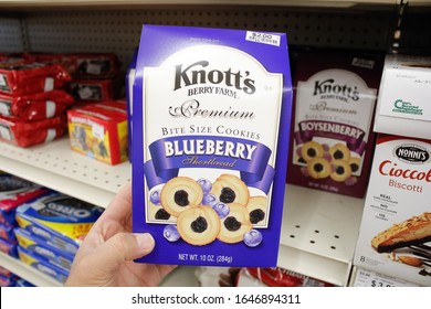 Long Beach, California/United States - 02/12/2020: A Hand Holds A Package Of Knott's Berry Farm Premium Bite Size Cookies Blue Berry Shortbread, On Display At A Local Grocery Store.