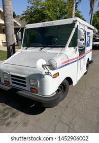 Long Beach, California/USA - July 16, 2019 USPS Truck Parked On Street As Postal Service Mail Carrier Is Hard At Work On A Sunny Summer Day