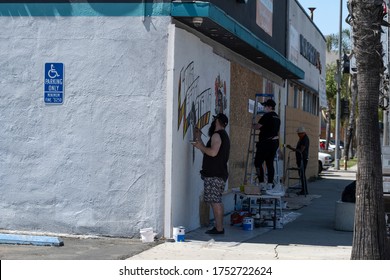 Long Beach, CA/USA - June 6, 2020: Artists Painting Over Graffiti After The Black Lives Matter Protests