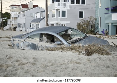 LONG BEACH ISLAND,NJ-NOVEMBER 1: A car is badly damaged by the storm surge and sand caused by  Hurricane Sandy in Holgate.Nov 1 2012, Long Beach Island, NJ