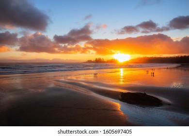 Long Beach, Near Tofino and Ucluelet in Vancouver Island, BC, Canada. Beautiful view of a sandy beach on the Pacific Ocean Coast during a vibrant sunset.