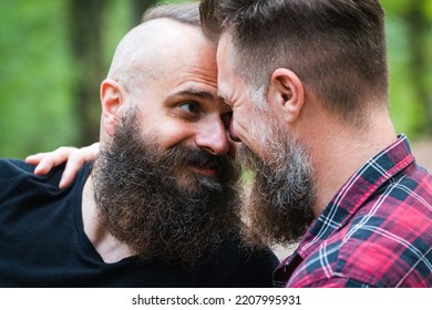 Long Beard Hipster Gay Couple Romantically Posing With Confidence In The Woods. Male Homosexual Partners In Late 30s, Attractive And Fashionable Look And Haircuts. 