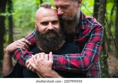 Long Beard Hipster Gay Couple Romantically Posing With Confidence In The Woods. Male Homosexual Partners In Late 30s, Attractive And Fashionable Look. 