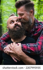 Long Beard Hipster Gay Couple Romantically Posing With Confidence In The Woods. Male Homosexual Partners In Late 30s, Attractive And Fashionable Look. 