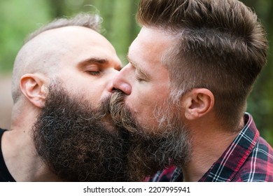 Long Beard Hipster Gay Couple Passionately Kissing. Male Homosexual Partners In Late 30s, Attractive And Modern Haircuts, Enjoying Intimate Moments. Close Up.