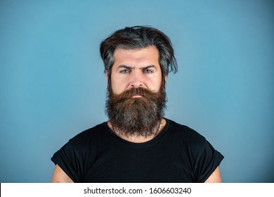 Long Beard. Perfect Beard. Close-up Of Young Bearded Man Standing Against Blue Background.