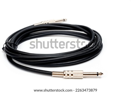 Long black jack cord for electric guitar, filmed on a white background. Stok fotoğraf © 