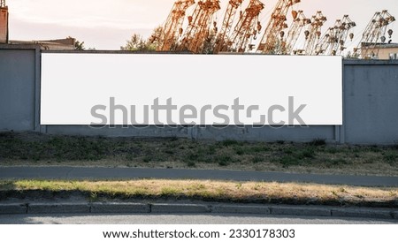 Long blank banner with empty space with mockup mounted on cement fence. White isolated hoarding at construction site.