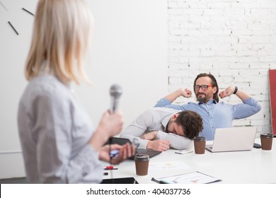 Long And Boring Presentation Of Business Woman In Office. Tired And Exhausted Men Listening To Her And Sleeping.