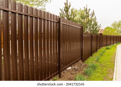 Long Brown Fence. Ventilated Fencing For A Farm Or Country House.