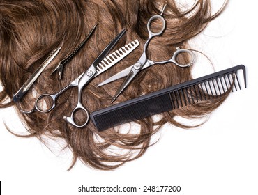 Long Brown Hair With Scissors On Close Up Isolated On White Background