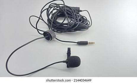 Long Cable Clip-on Mic Isolated On White Background. Small Lavalier Microphone With Clip. Professional Sound Recording Equipment. Lapel Mic.