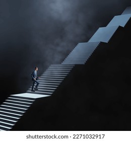 Long career and long way to success concept with man in blue suit climbs dark stairs illuminated from above on abstract dark foggy background