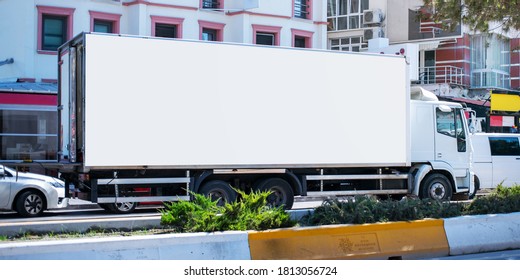 Long Cargo Truck With Empty White Banner On Bodywork At City Street