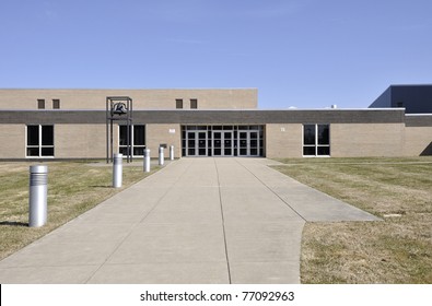 Long concrete sidewalk leading into a school building