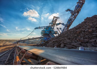 Long conveyor belt transporting ore - Shutterstock ID 528869884