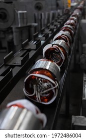 Long Conveyor Line For Production Of Electric Motors. Industrial Company Manufacture - Stators On Assembly Line Of Semi-automated Manual Production. 20th Century Technology, Obsolete Factory Processes