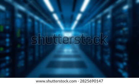 A long corridor in a data center filled with server racks illuminated by cool blue LED lights.