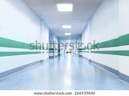 long corridor in hospital with doors and reflections