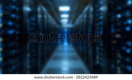 A long corridor in a modern data center filled with rows of server racks and illuminated by blue lights.