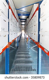 Long corridor of white boxes in warehouse