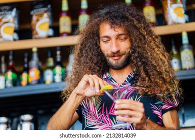 long curly haired mixed race man barman making beverage alcoholic drink at beach shack in tropic - Powered by Shutterstock