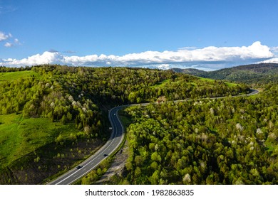 Long Curvy Forest Road In Mountains Aerial View