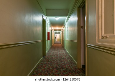 Long Dark And Creepy Hallway In An Old American Apartment Building