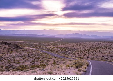 Long desert highway leading into a distant mountain range, captured at sunrise under a vibrant sky. Perfect representation of freedom, solitude, and adventure on the open road - Powered by Shutterstock