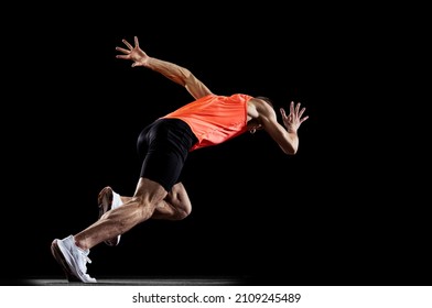 Long Distance Run. Male Professional Athlete In Uniform Training Running Isolated Over Black Studio Background. Maintaining Health And Strength. Concept Of Sport, Healthy Lifestyle, Motion, Ad