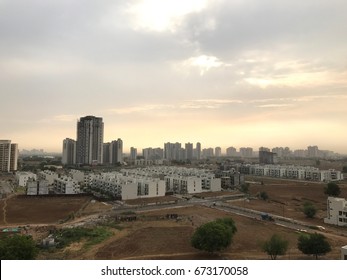 Long Distance View Of Gurgaon, India With Barren Lands And City Landscape