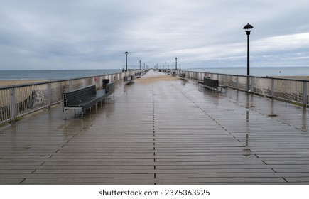 long empty boardwalk pier in rain - Powered by Shutterstock