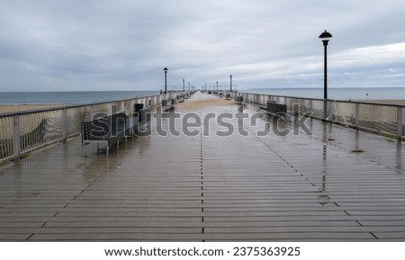 long empty boardwalk pier in rain
