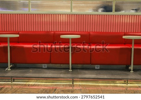 Long Empty Booth Seating Area In Retro Diner Features Small Round Pedestal Tables