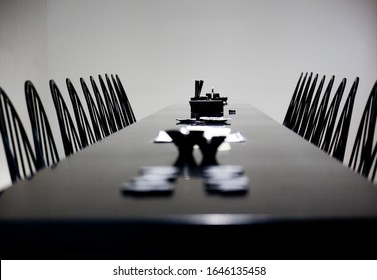 Long Empty Dinner Table With Two Rows Of Chairs