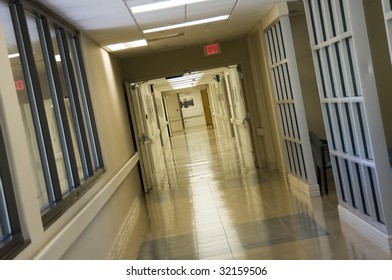 Long Empty Hospital Hallway Showing Exit Sign