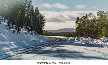 long empty road in winter snow and cold  surroundings vanishing in the horizon 