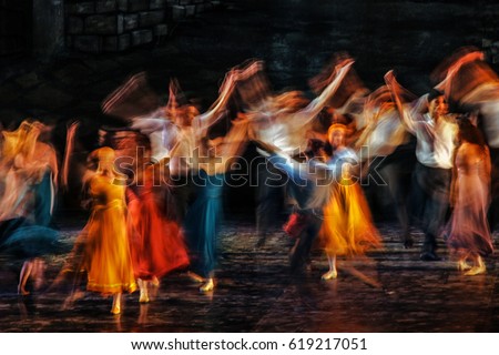 Long exposed and colorful photo of the dancers performing their art in a musical. 