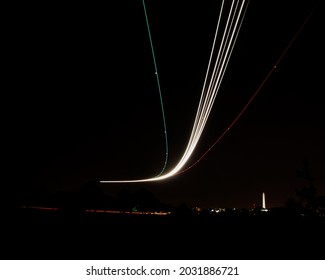 Long Exposure Of An Airplane Landing At Night Near Washing DC