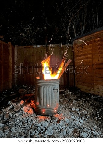 Long Exposure Backyard Mini Bonfire. Burning Wood in a Bin. Trash Can Garden Fire. 