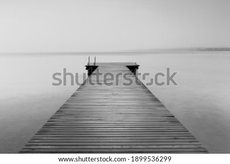 Long exposure in black and white of a pier on the lake