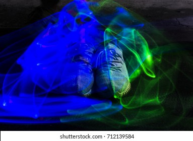 Long Exposure Blue And Green Light Lines Movement Over Sneakers