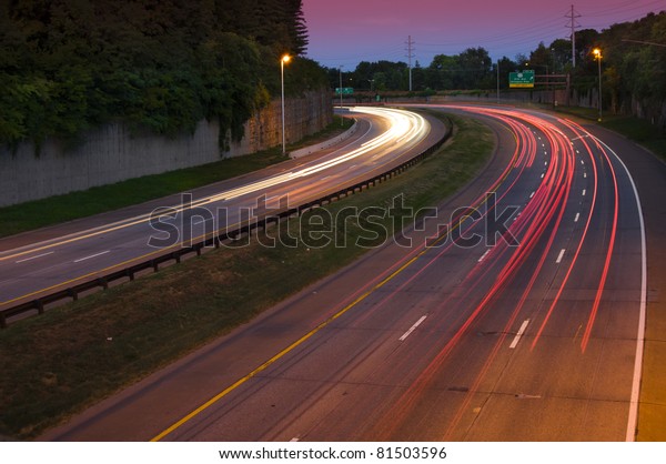 Long exposure of a\
busy highway at dusk