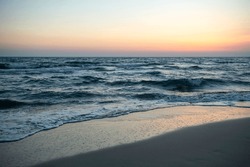 Long Exposure By The Sea. Waves Break Against Stones. Sunset At The Beach. Long Exposure At Night By The Sea. Patara Beach Antalya Turkey