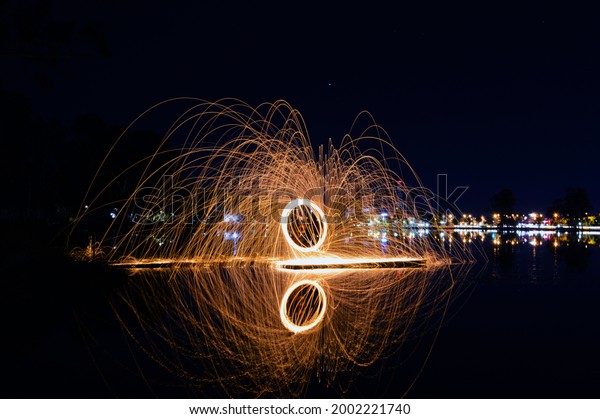 a long exposure\
capturing steel wool burning whilst being spun around by the\
beautiful shepparton lake