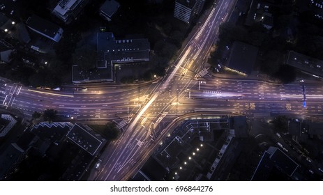 Long Exposure Of Cars Crossing A Street In A City At Night -  Drone Top View