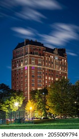 Long Exposure Of Clouds Moving Across A Dark Blue Sky Over A Highrise Residential Building In The Lakeview Neighborhood Along Lake Shore Drive In Chicago At Night.