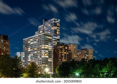 Long Exposure Of Clouds Moving Across A Dark Blue Sky Over Modern Residential Highrise Buildings In The Lakeview Neighborhood Along Lake Shore Drive In Chicago At Night.