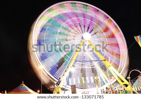 Long exposure of a colorful ferris wheel at night